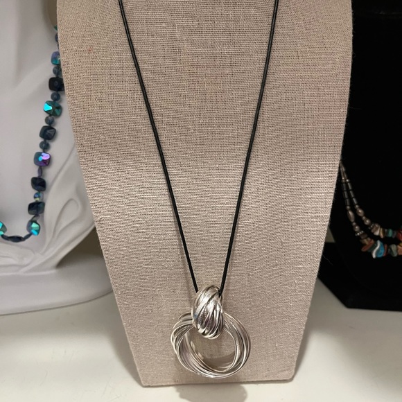 N125 Multiple hammered flat metal strips create a pendant with knot on cord - Picture 5 of 8